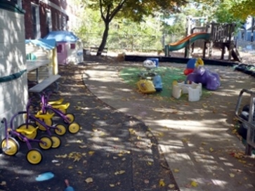 The large outdoor play area has jungle gyms and many toys.